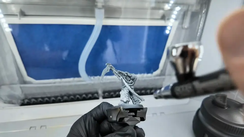 Airbrushing grey primer onto the Death Guard miniature inside the spray booth, Episode 03