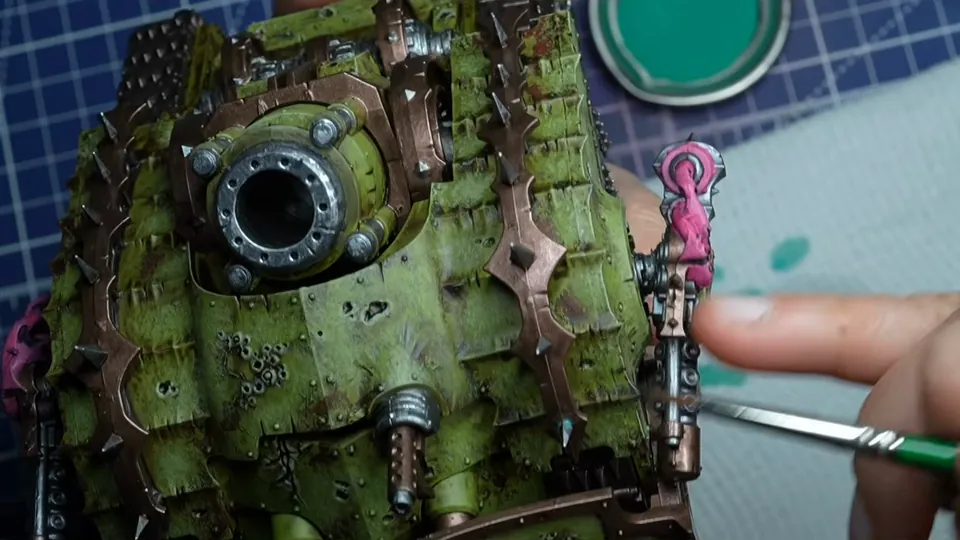 Dabbing turquoise corrosion onto the copper trims of the tank, a pot of turquoise paint behind, Episode 07