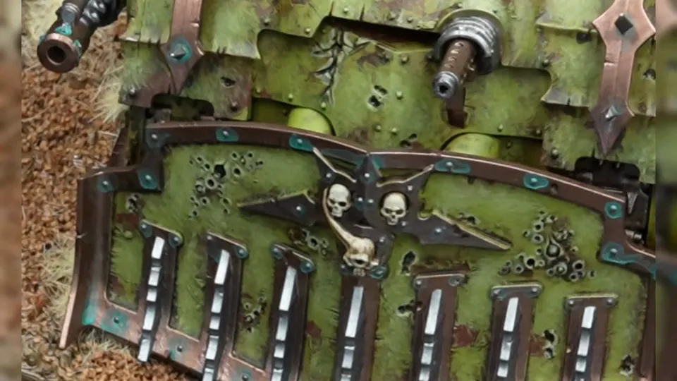 Close-up of the finished dozer blade: copper trim with turquoise corrosion, silver teeth and skulls, Episode 07